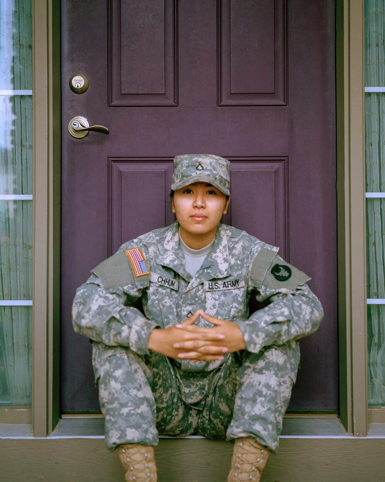 A U.S. Army soldier sitting on her home's front step