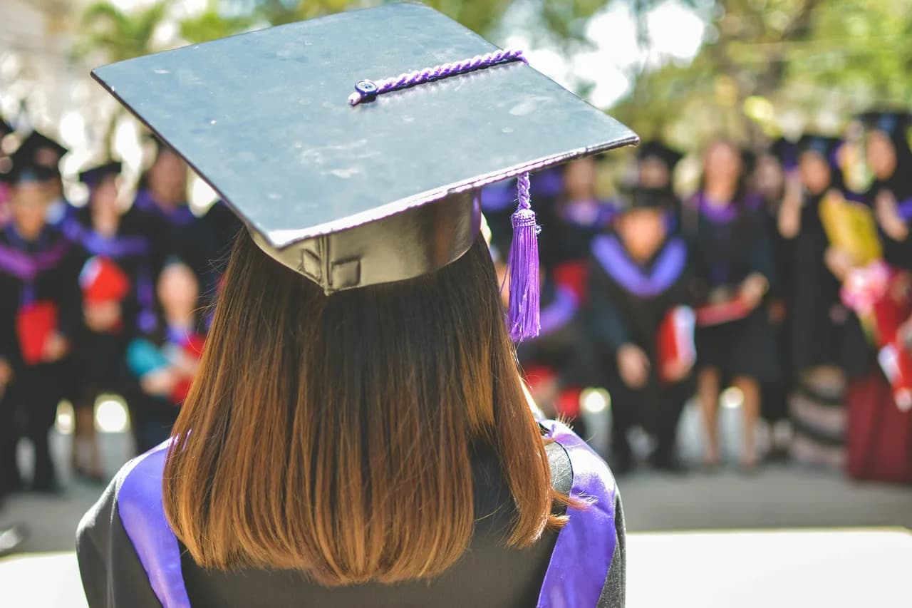 A graduate in cap and gown at commencement